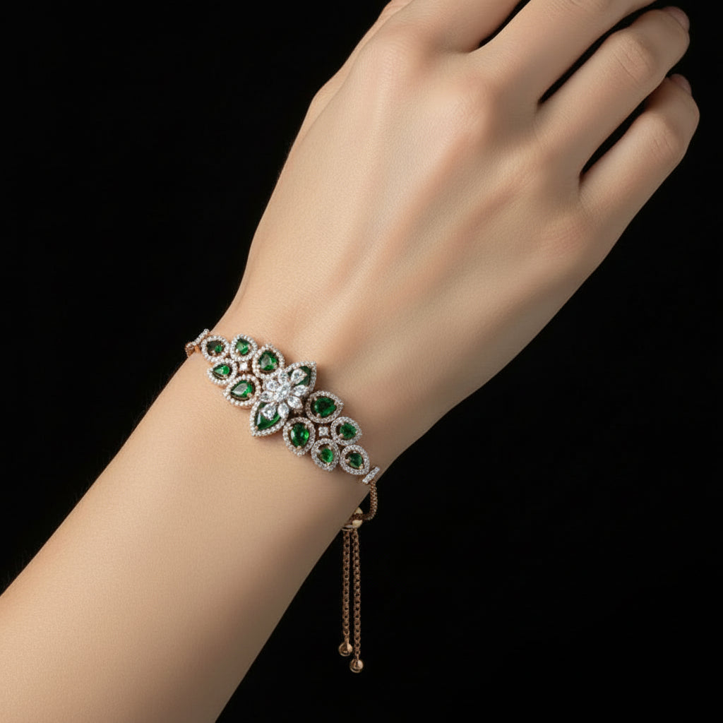 Gold necklace with emerald and diamond pendant on a black background