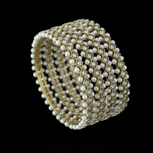 Pearl bracelet on a gray stand with 'SAHELI' branding.