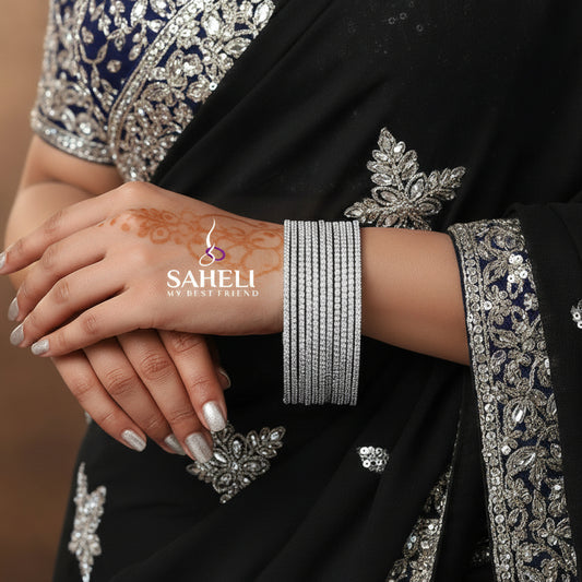 Set of silver bangles on a black cushion with 'SAHELI' branding.