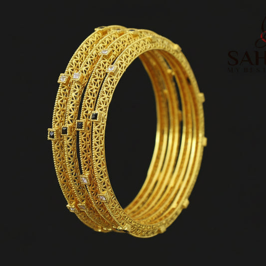 Gold bangles on a dark background with 'Saheli' brand logo.