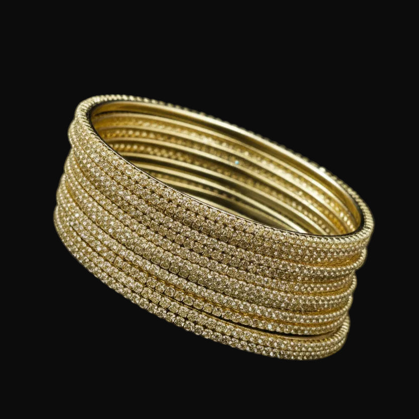 Gold jewelry set on a black background with 'SAHELI' branding.