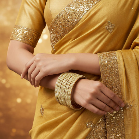 Gold jewelry set on a black background with 'SAHELI' branding.