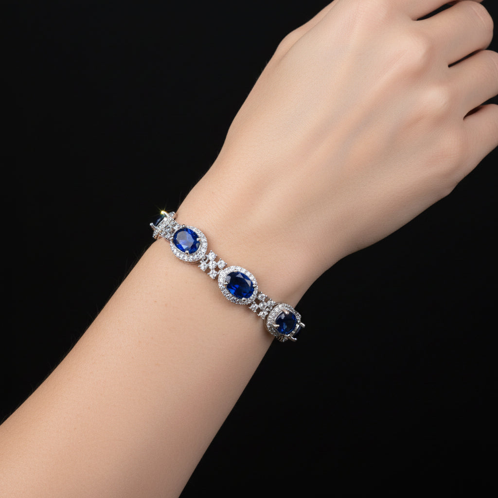 Jewelry necklace with blue stones on a black background, featuring the brand 'Saheli'.