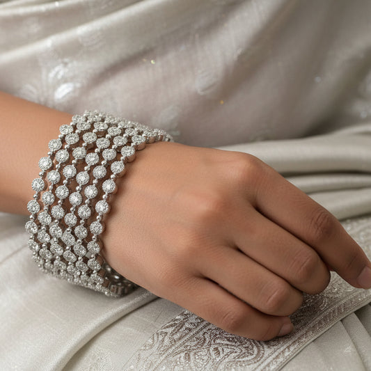 Silver bracelet on a black stand with 'SAHELI' branding in the background