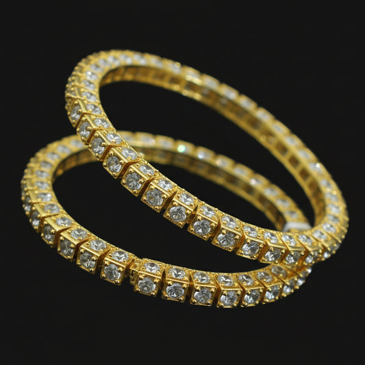 Gold bracelet with diamond accents on a black mannequin hand, branded 'Saheli'.