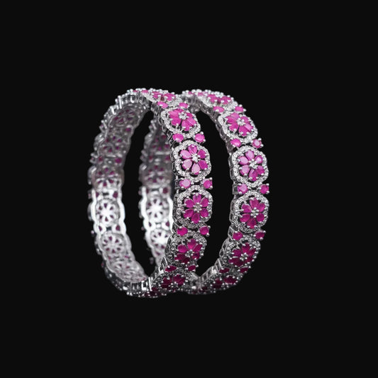 Pink bracelet with silver accents on a black background, featuring the brand 'Saheli'.