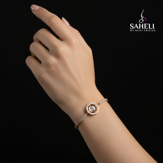 Gold bracelet with a central gemstone on a black background, featuring the brand 'SAHELI'.
