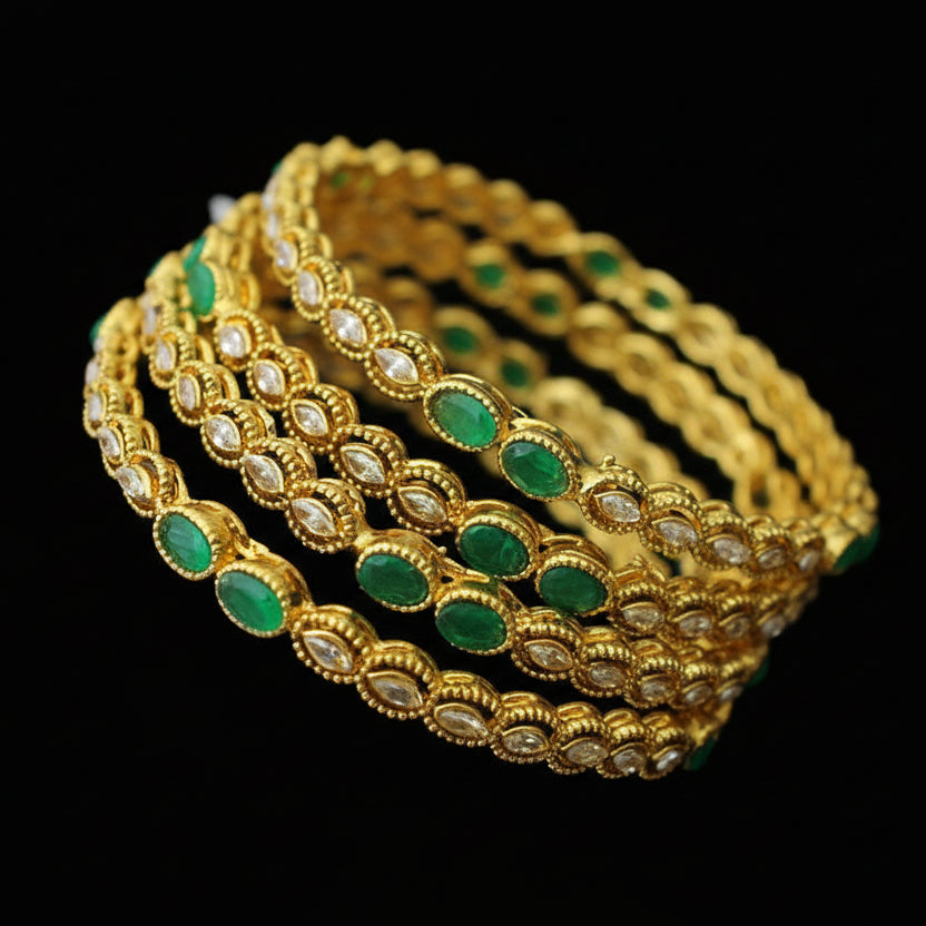 Gold and green bangles on a black stand with 'SAHELI' branding.