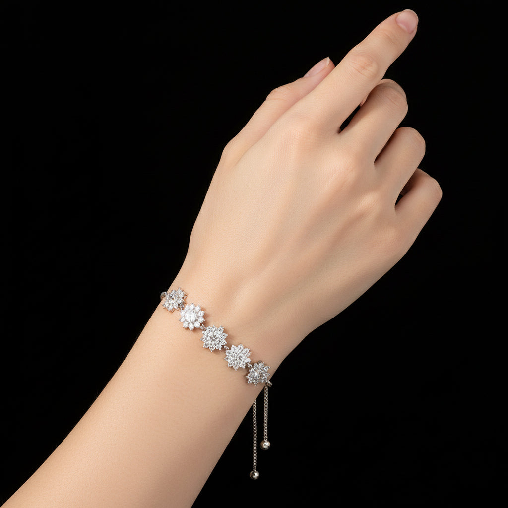 Silver bracelet with floral designs on a brown background