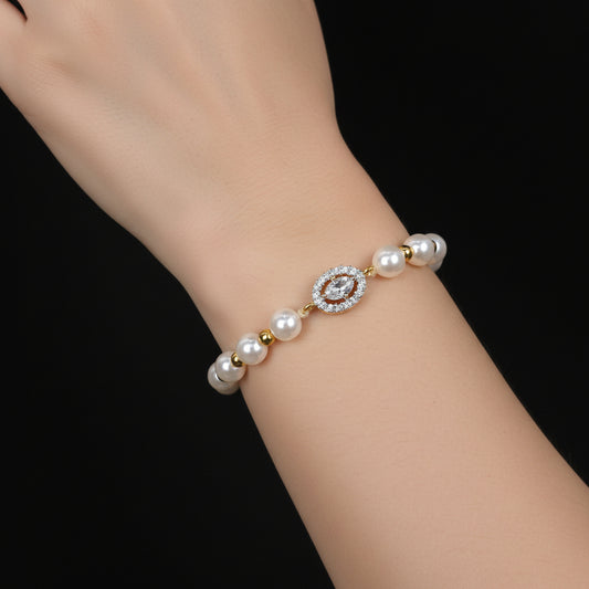 Pearl bracelet with a central gemstone on a black background, featuring the brand 'Saheli'.