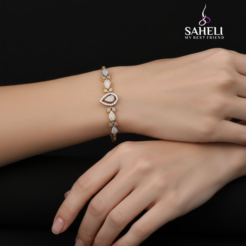 Decorative bracelet with gold and diamond accents on a dark background, featuring the brand 'Saheli'.