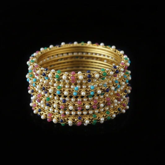 Decorative brooch with multicolored stones on a dark background, branded 'SAHELI'.