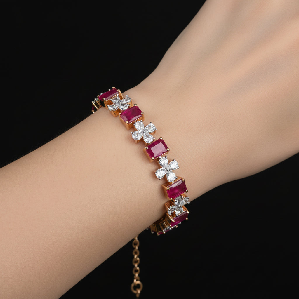 Jewelry piece with red gemstones and diamonds on a black background, featuring the brand 'Saheli'.