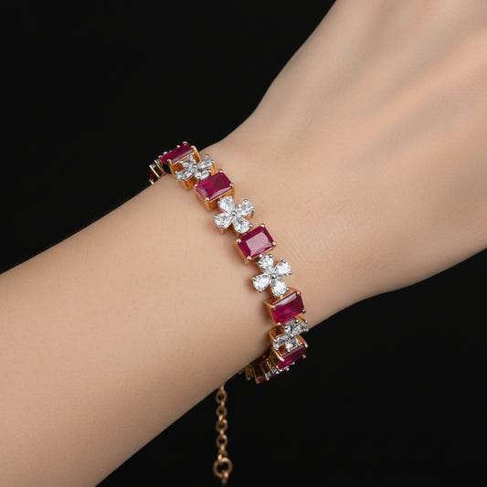 Jewelry piece with red gemstones and diamonds on a black background, featuring the brand 'Saheli'.