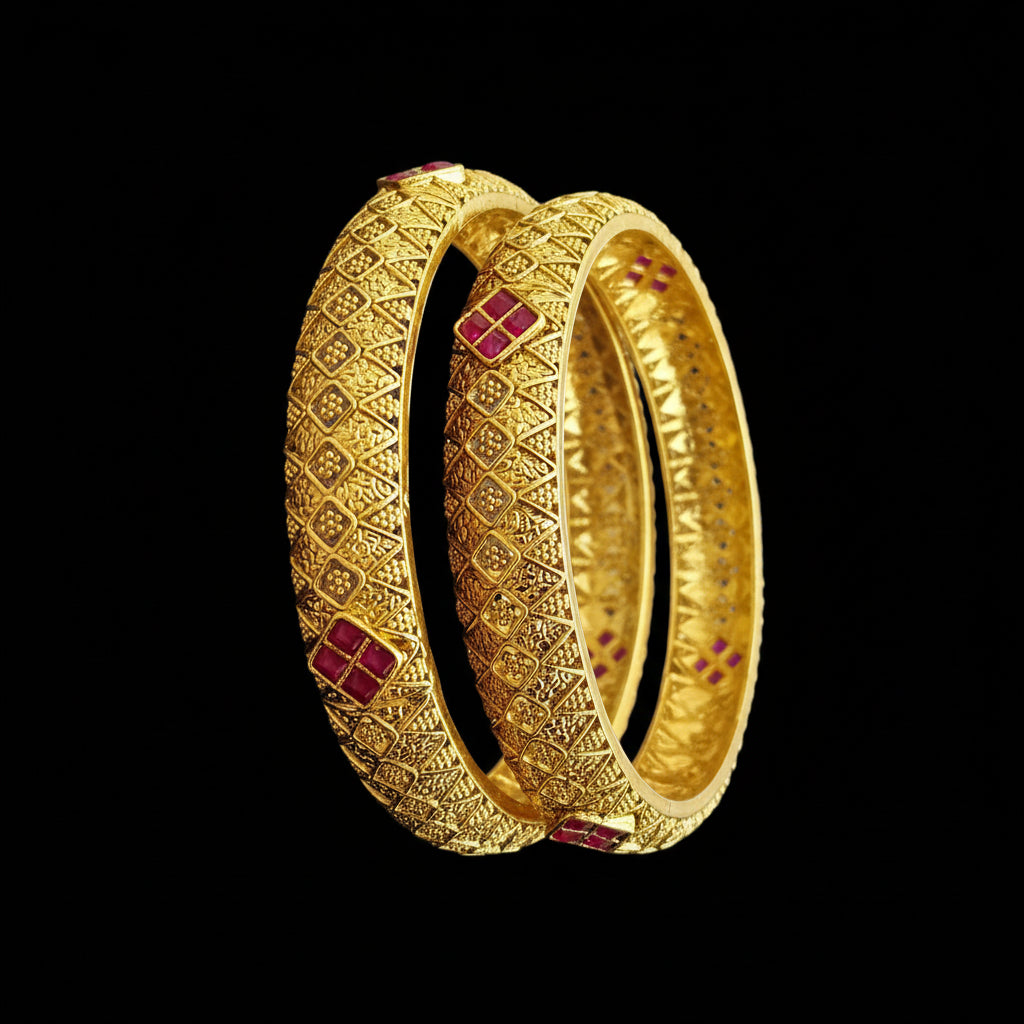 Gold bangles with intricate designs on a gray background, featuring the brand 'Saheeli'.