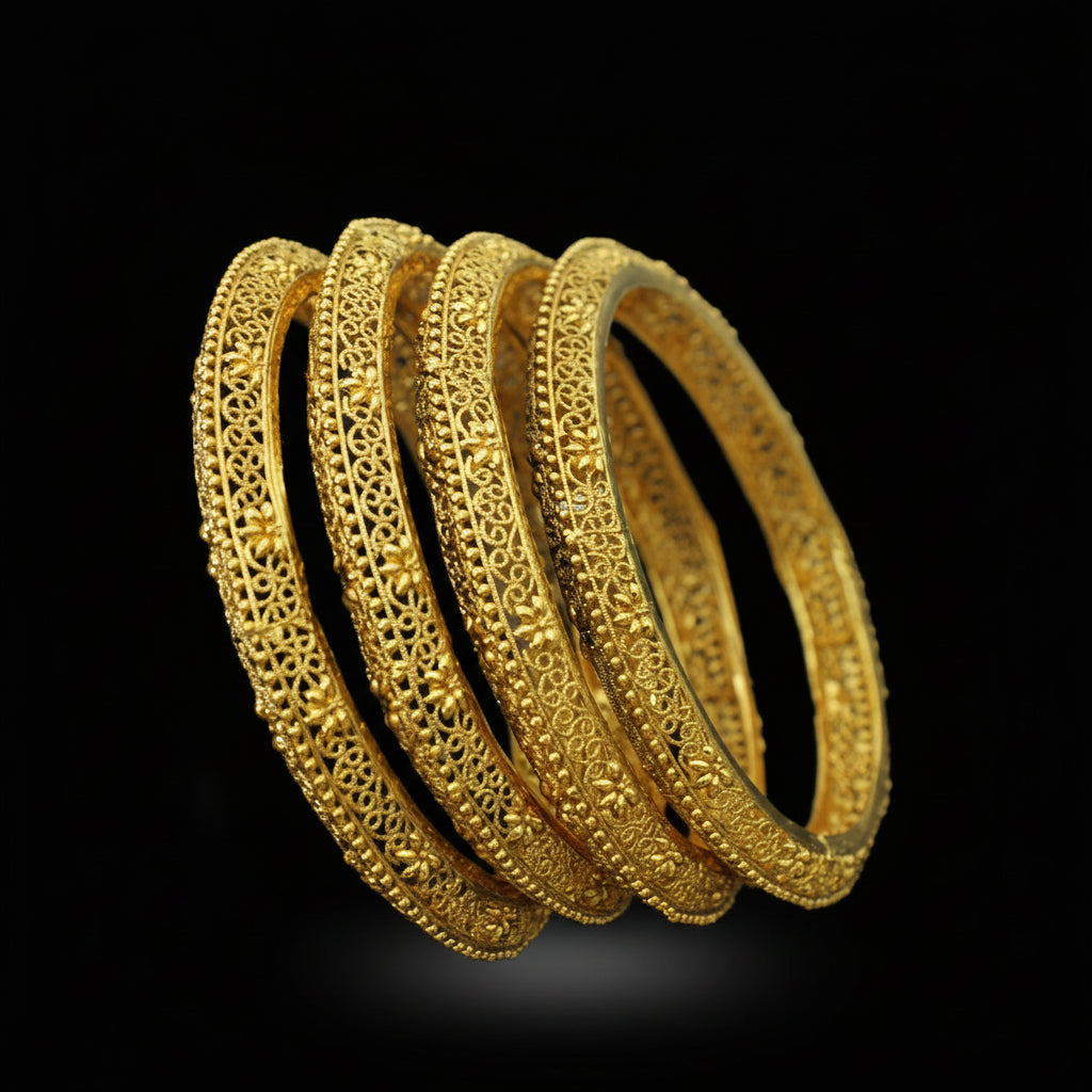 Set of gold bangles on a black stand with 'Saheli' branding.