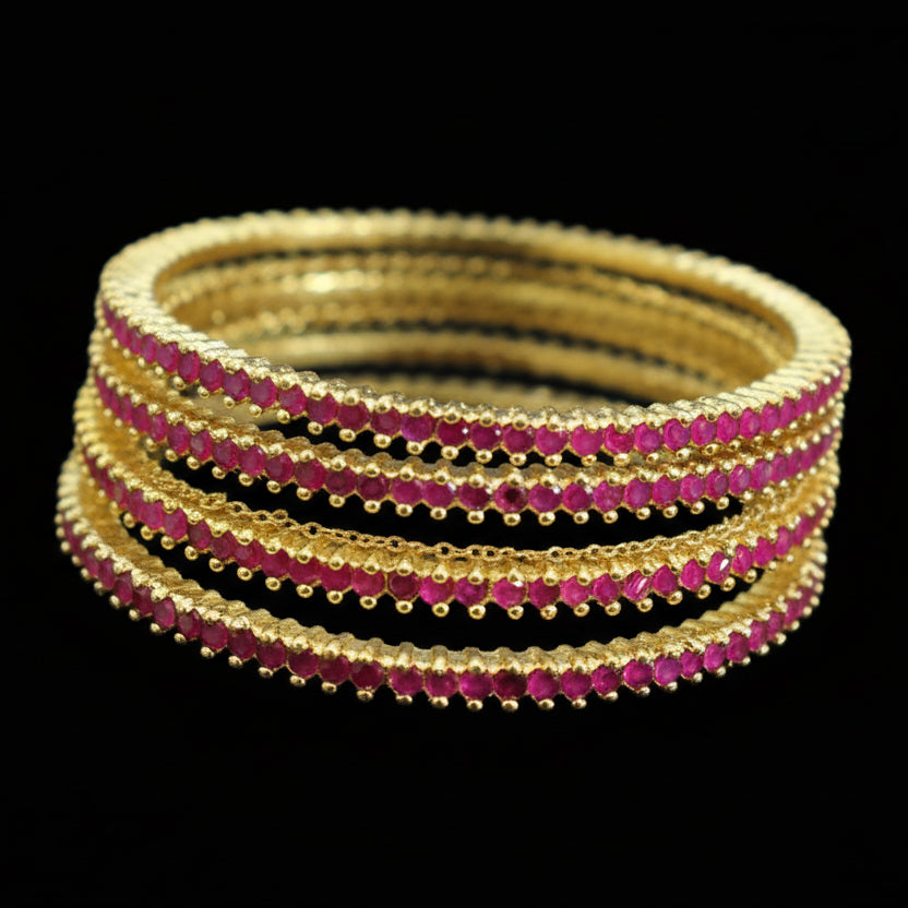 Set of gold and red bangles on a mannequin with 'SAHELI' branding.