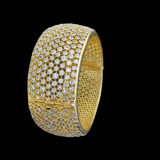 Gold bracelet with diamonds on a dark background, branded 'Saheili'.