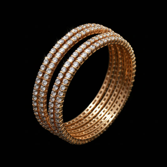 Gold bangles with clear stones on a black background, branded 'Saheli'.