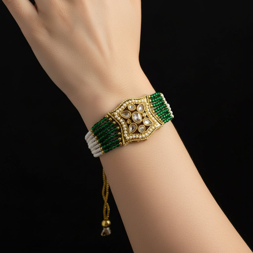 Necklace with green and white beads on a dark background, featuring the brand 'Saheli'.