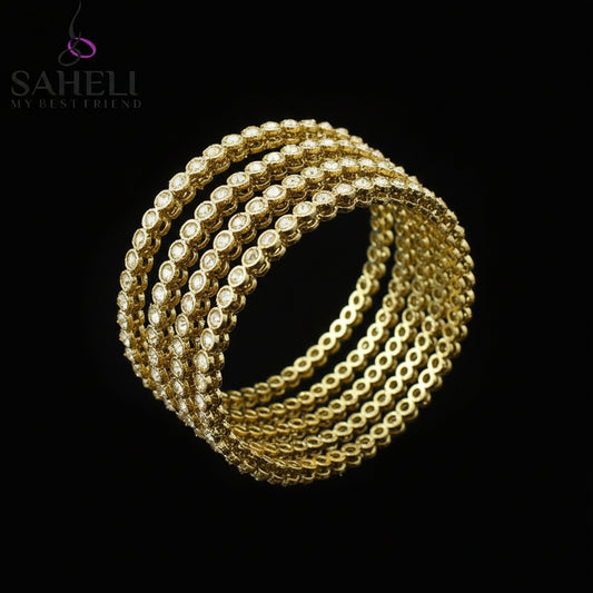 Gold bracelets on a black stand with 'SAHELI' branding on a gray background
