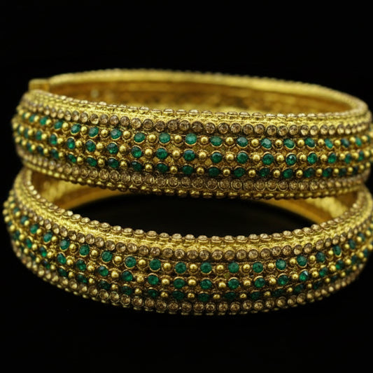 Gold bangles with turquoise stones on a dark background, featuring the brand 'SAHELI'.