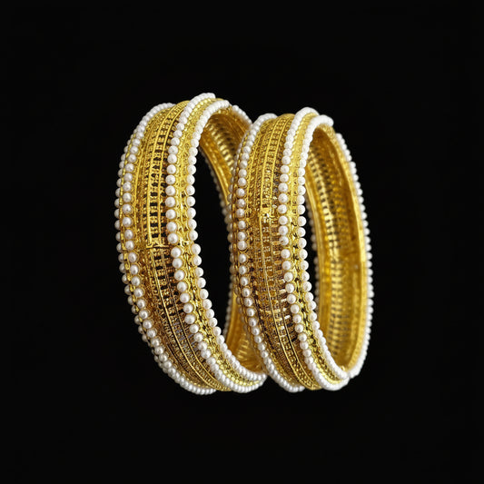 Gold and white beaded bangles on a gray background with 'SAHELLI' branding.