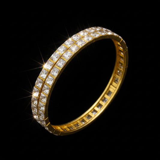 Gold ring with diamond stones on a black stand against a gray background, featuring the brand 'Saheli'.