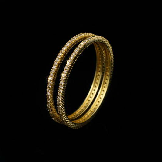 Gold bangles on a black stand with 'SAHELI' branding.