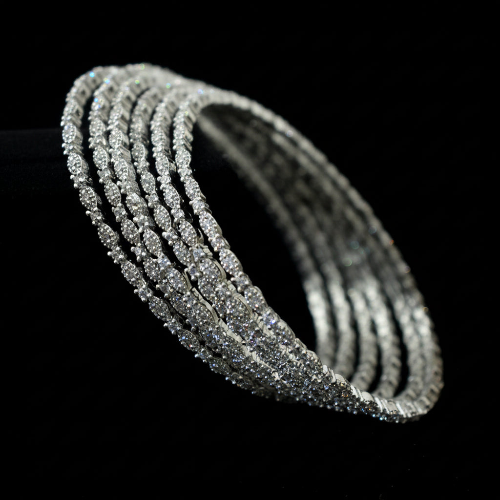 Silver bracelet with multiple rows of diamonds on a dark background, branded 'Saheli'.