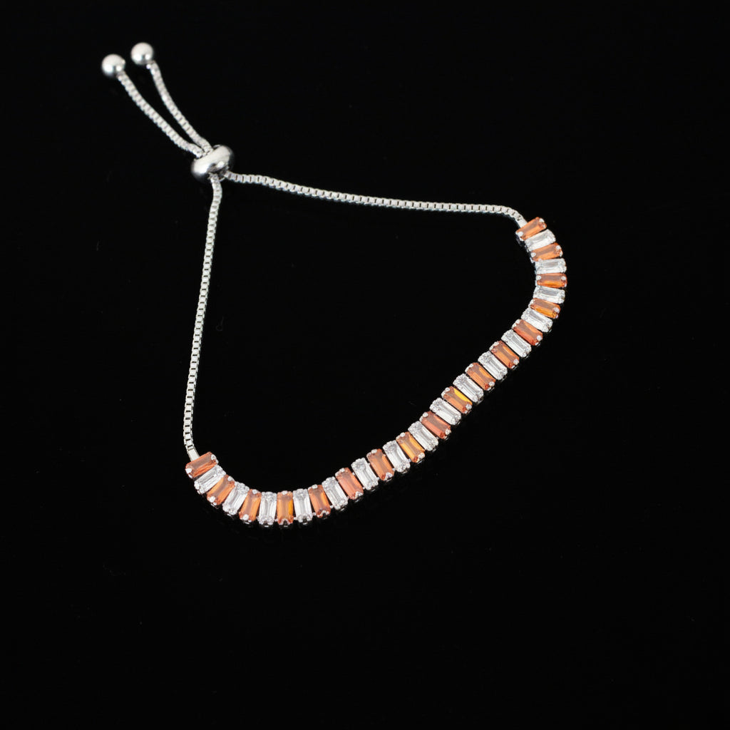 Bracelet with orange and silver beads on a dark gray background