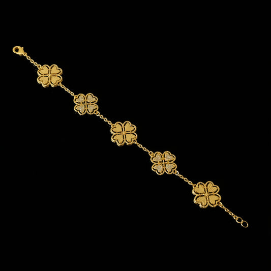 Gold bracelet with clover-shaped charms on a black background