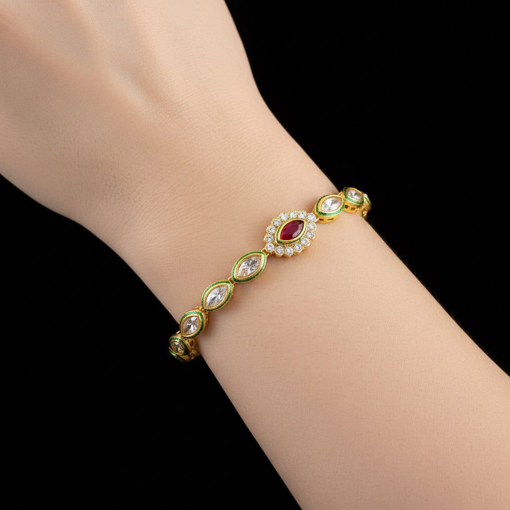 Gold bracelet with gemstones on a dark background, featuring the brand 'Saheli'.