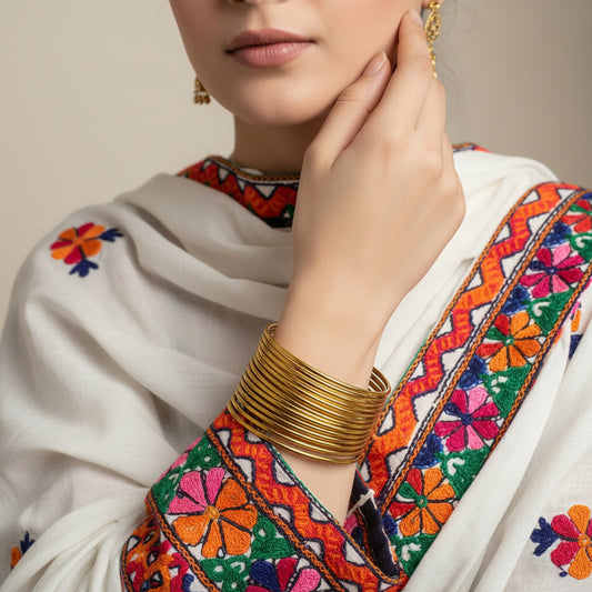 Gold bracelet on a dark gray background