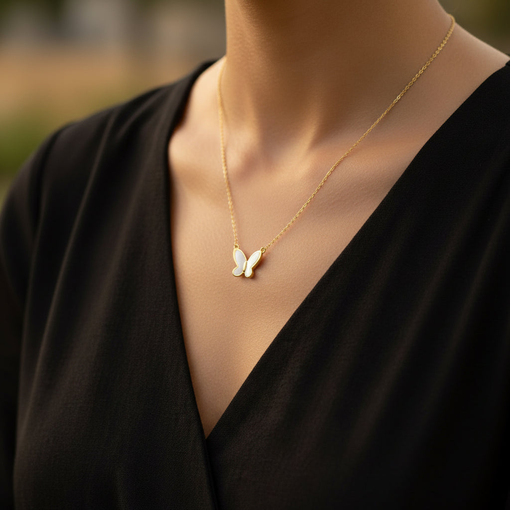 Gold necklace on a Saheli branded card against a dark background