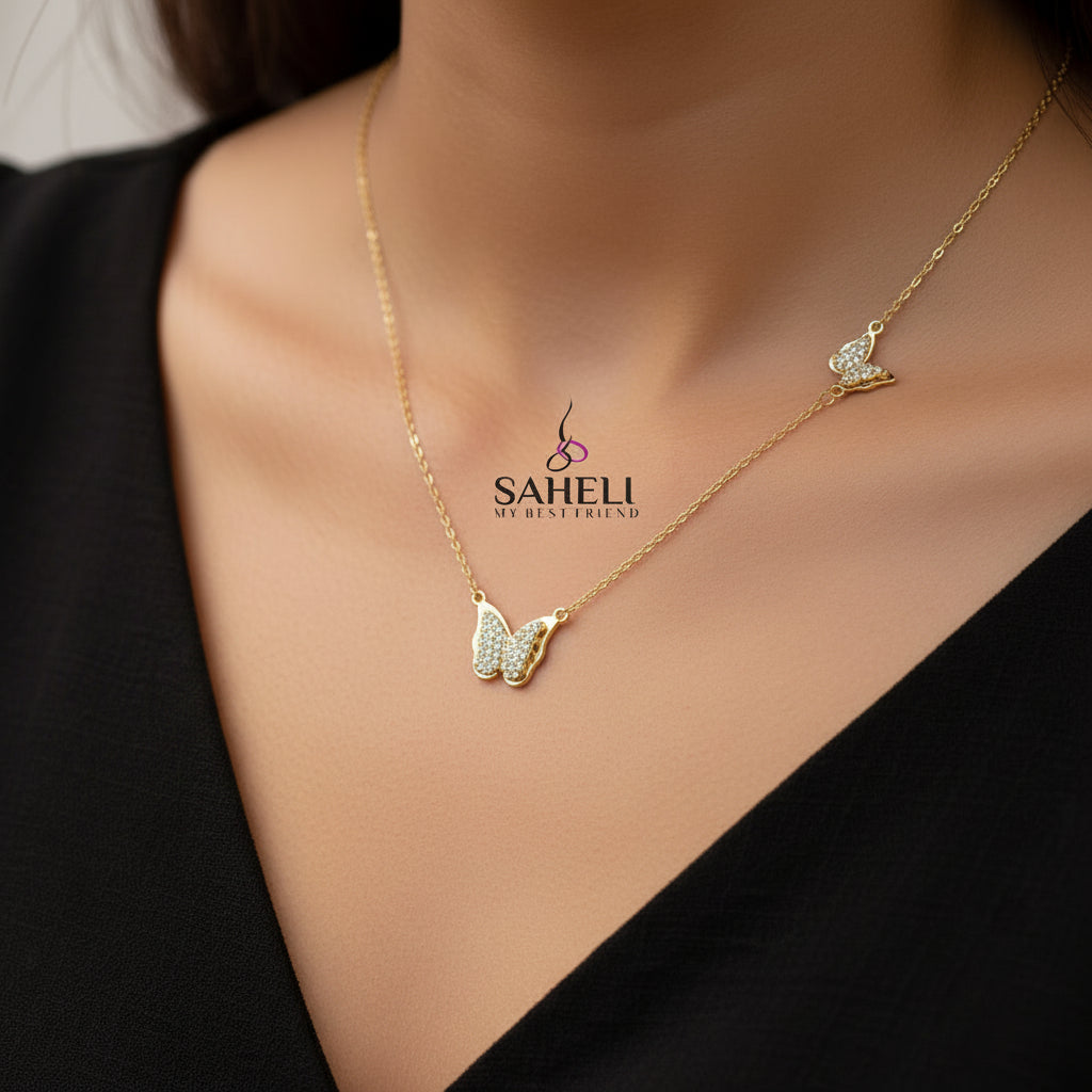 Gold butterfly necklace on a branded card with 'A.B.N' and 'Saheli' branding.