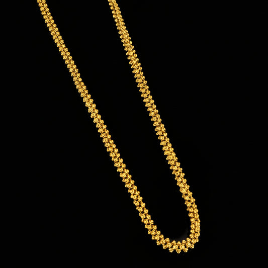 Gold necklace on a gray background with 'SAHELI' branding.