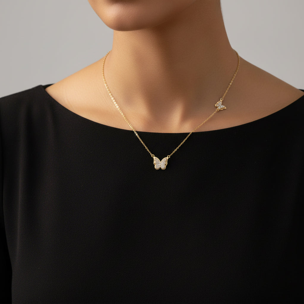 Gold butterfly necklace on a branded card with 'A.B.N' and 'Saheli' branding.