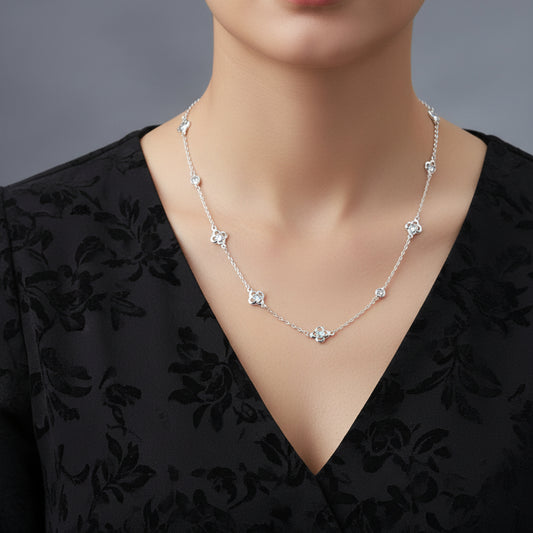 Silver necklace on a black mannequin with 'Saheli' brand logo.