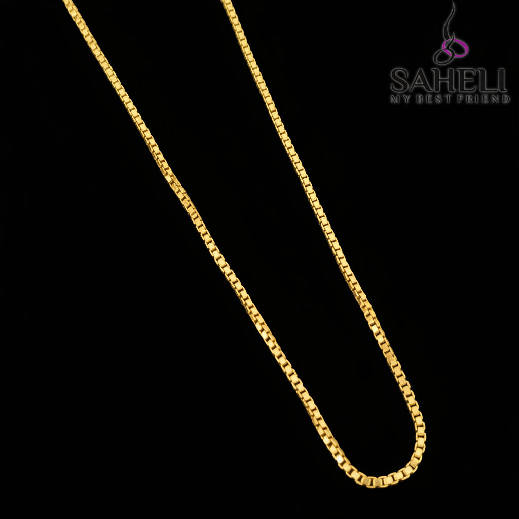Gold chain necklace on a gray background with 'SAHELI' branding.