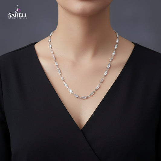 Silver chain necklace on a black mannequin with 'SAHELI' branding.