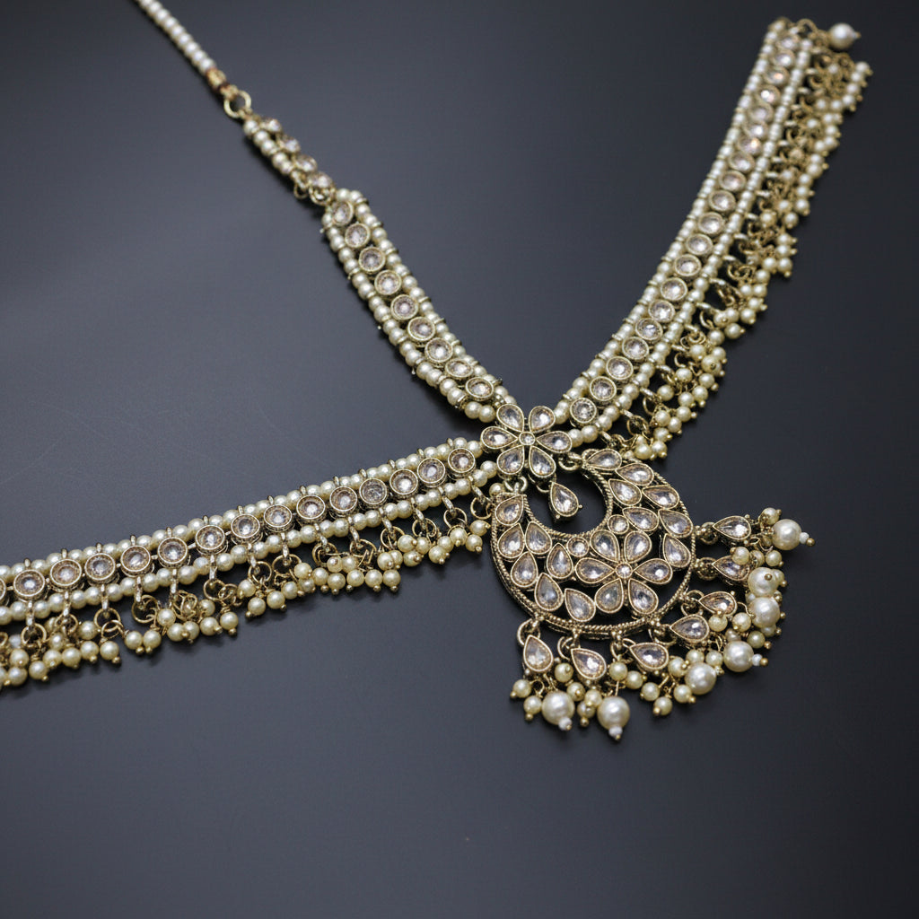 Delicate necklace with pearls and crystals on a dark background