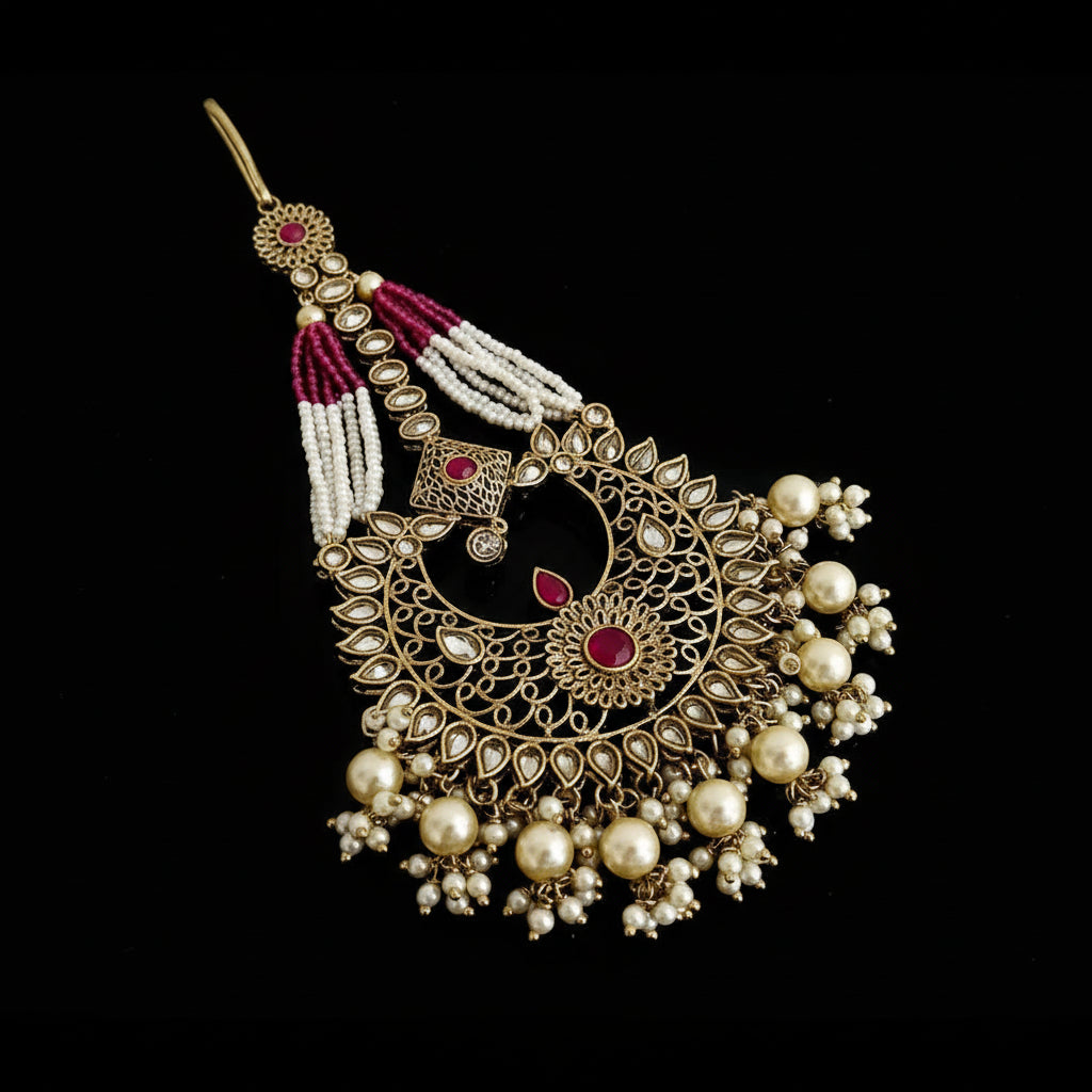 Ornate gold and pearl hairpin with red stones on a black background