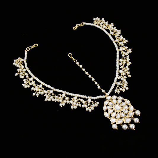 Delicate necklace with floral design on a dark background, featuring the brand 'Saheli'.