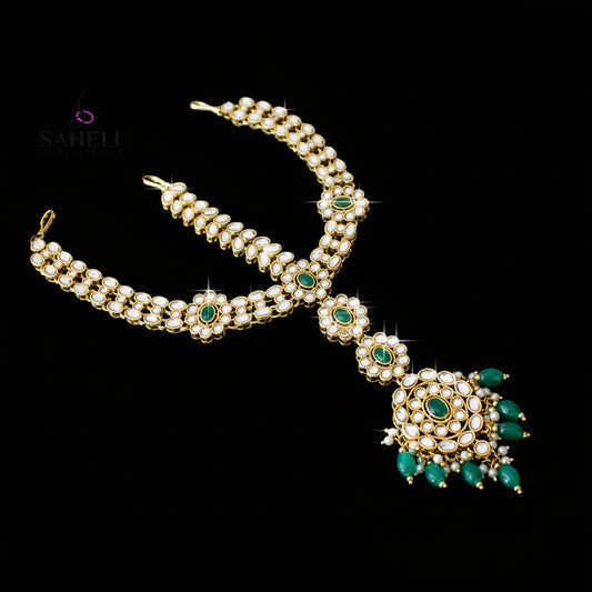 Ornate gold and green jewelry set on a dark background with 'Sahelli' branding.