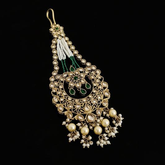 Decorative earrings with intricate design on a dark background