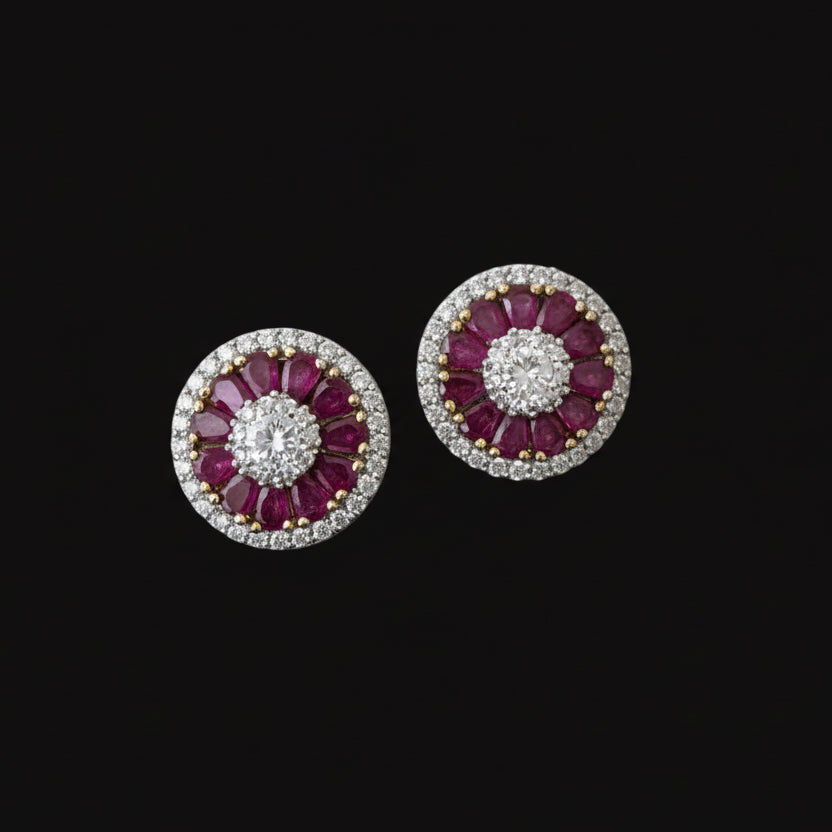 Pair of pink gemstone earrings on a gray stand with 'Saheli' branding.