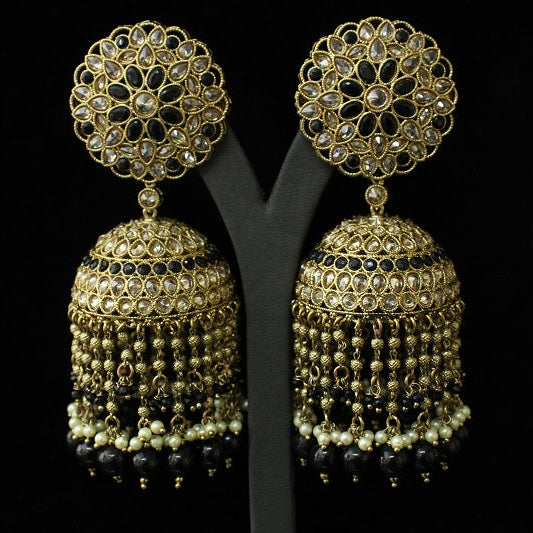 Gold and black earrings on a black background