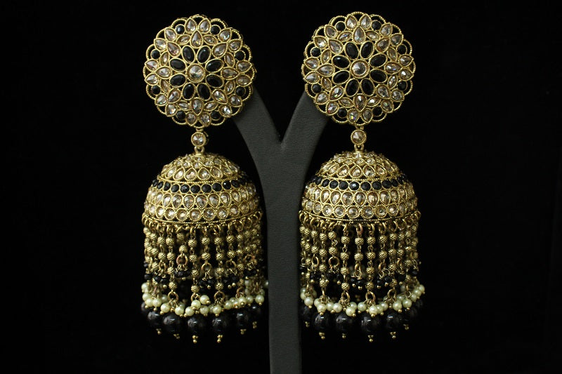 Gold and black earrings on a black background