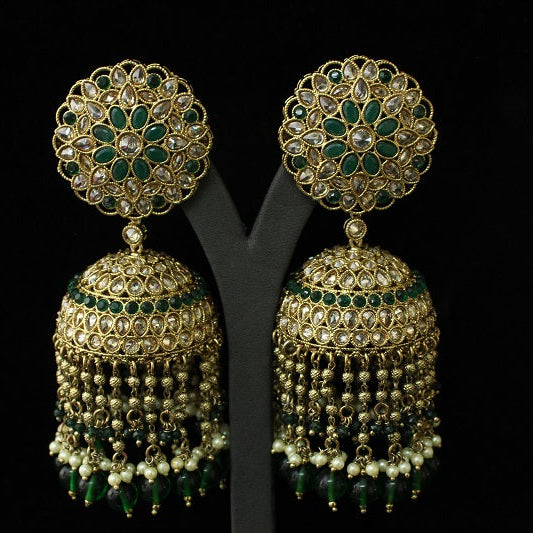 Pair of gold and green floral earrings on a black background